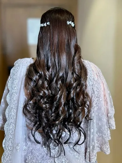 The back view of these beautiful soft curls, adorned with just a few simple, bow-like clips for a touch of sparkle.