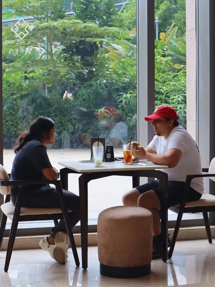 A casual lunch meeting by the window. The natural light and green surroundings at our RMZ location make it a refreshing spot for a break in your day.