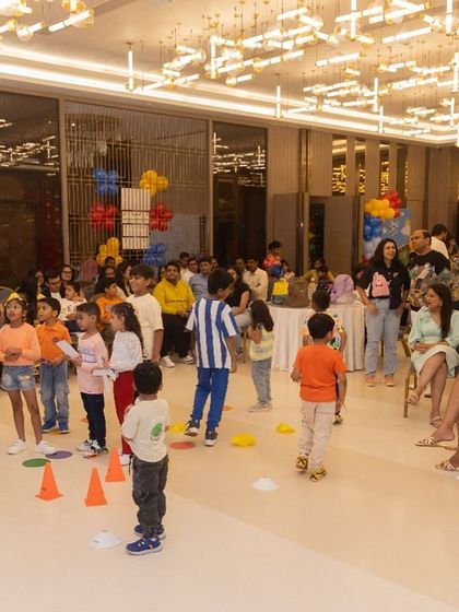 A wide view of the party hall during a group game. It shows how I can transform a large space into an engaging environment for dozens of children and adults.