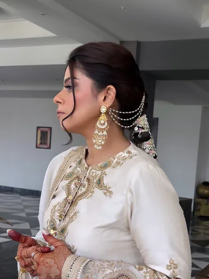 A side view showing how the parandi braid is integrated with the rest of the hairstyle. The front is softly styled to frame the face, while the back is all about the drama of the braid.
