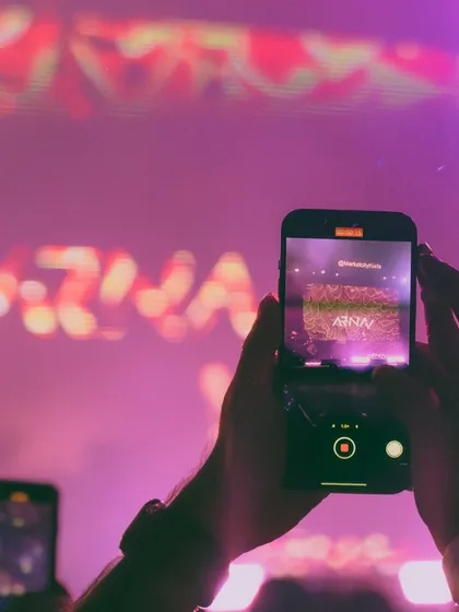 A shot from the audience's perspective, capturing my performance on their phones. This reflects the engaging and memorable moments I create that people want to share.