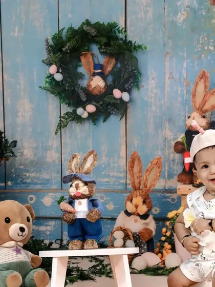 An adorable Easter-themed shoot, with a baby sitting among a family of plush bunnies and spring flowers.