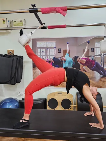 This is what peak control and strength looks like on the Cadillac. This inverted position challenges the entire body, requiring core stability, back flexibility, and focused breathing to achieve this beautiful line.