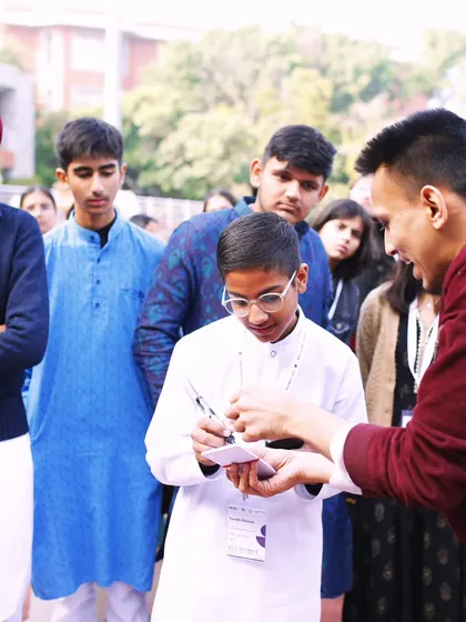 The best part of any workshop is the one on one moments. Here, I'm showing a student a little secret behind a mind reading effect. Seeing that 'aha!' moment on their face is the real magic.