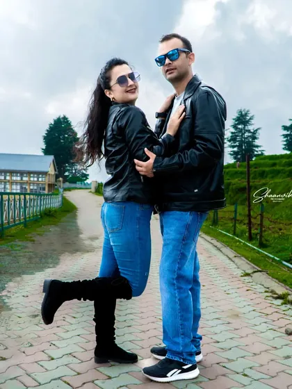 A stylish pose from a pre-wedding shoot. The matching leather jackets and cool sunglasses give this photo a modern, edgy vibe.