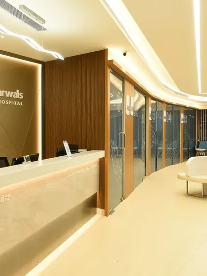 The reception and waiting area at Dr. Agarwal’s Eye Hospital in Bangalore was designed to be calming and efficient. The curved forms, warm lighting, and clear navigation reflect our patient-first approach to healthcare facility planning.