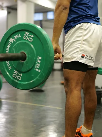 A close-up on the deadlift setup. Proper form starts from the ground up. We teach our athletes to engage the right muscles and maintain a strong posture before even lifting the weight.