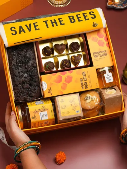 This shot uses hand modeling to make the gift hamper feel more personal and aspirational. It helps customers imagine themselves receiving or gifting the beautiful box.