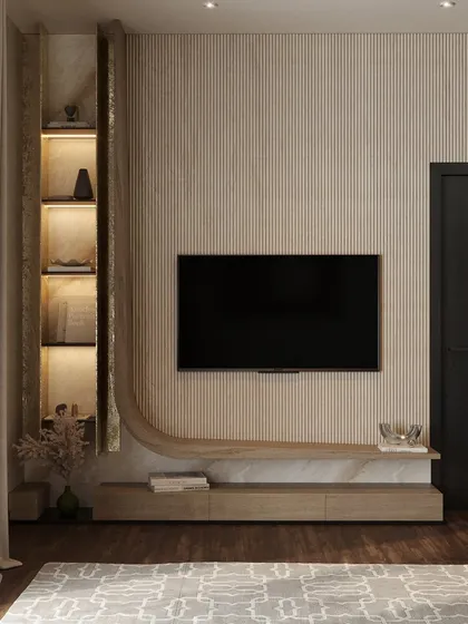 A detailed look at the custom-built TV and shelving unit. The fluted wood texture and curved design create a soft, organic feel, while integrated lighting highlights decorative objects.