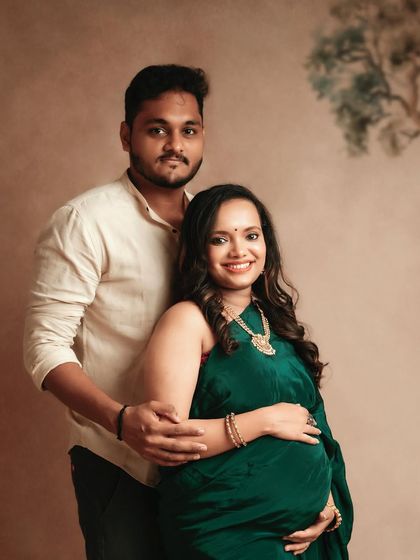 A classic couple's portrait. The mom-to-be looks stunning in her green saree, and the connection between them is so sweet.