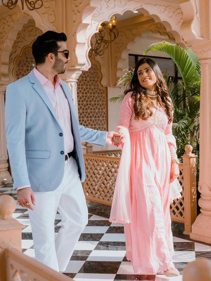 Another shot showcasing the beautiful pre-wedding location and the couple's coordinated outfits. Her makeup is fresh and radiant.