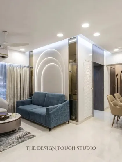 This view shows the open layout connecting the living and dining areas. The consistent design elements, such as the color palette and lighting, ensure a smooth visual transition between the spaces.