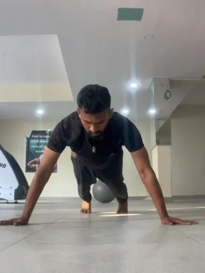 The bottom of a wide pushup, focusing on control and full range of motion. It's not about how many you do, but how well you do them.