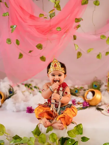 A heart full of joy and a smile that lights up the room. Our themed photoshoots, like this adorable Janmashtami session, are designed to celebrate special occasions and your baby's delightful personality with vibrant, creative setups.