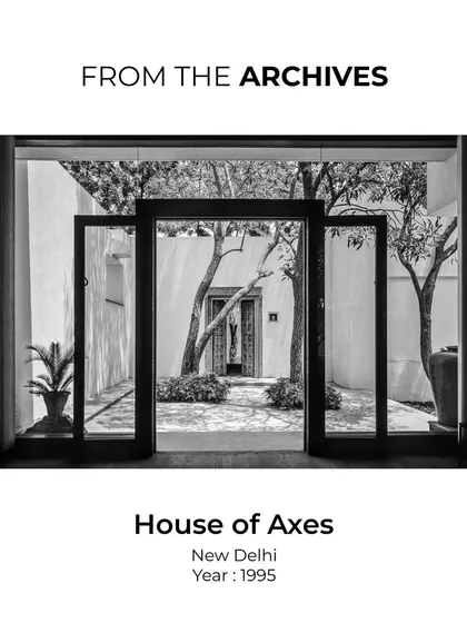 A view through open doors into a courtyard at the House of Axes. This archival image captures the project's core idea of framing nature and creating a timeless architecture.