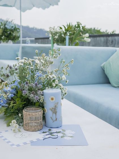 A custom-printed candle and stationery sit on a table at the mountain ceremony, showcasing our attention to personalized details.