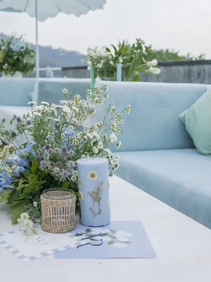 A custom-printed candle and stationery sit on a table at the mountain ceremony, showcasing our attention to personalized details.