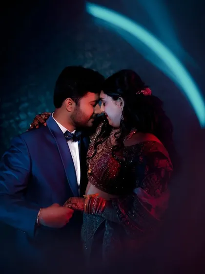 A dramatic and artistic portrait using creative lighting to create a moody, cinematic feel for this intimate pre-wedding shot.