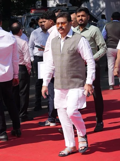 Here is another view of politician Prasad Lad wearing a classic checked waistcoat over a white kurta. This combination provides a look of authority and traditional grace, tailored for public appearances.