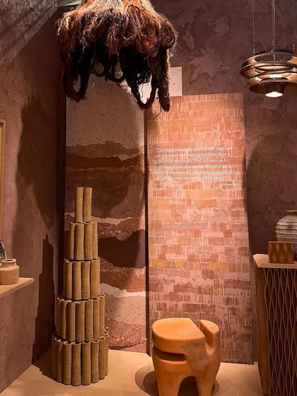 Another curated display from the 'Soil' installation, showing how different forms and materials can be used to interpret a single theme. The arrangement includes sculptural furniture and layered wall panels.