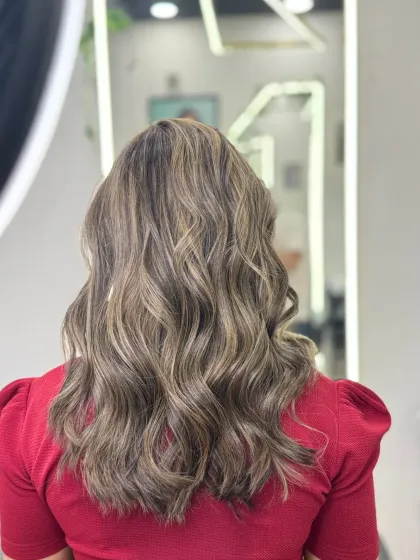 A back view of my smoke blonde classic highlights. This cool-toned blonde adds a sophisticated brightness and depth, styled here in soft waves to showcase the blended colors.