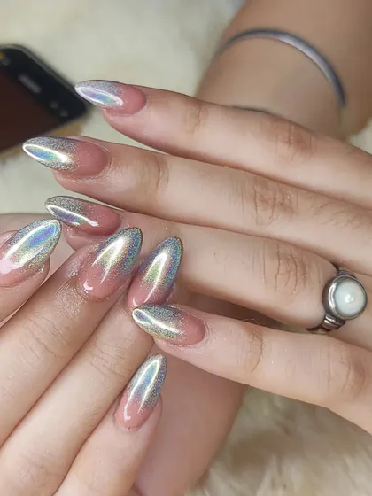 A full view of the holographic chrome ombré nails, showing the seamless transition from a sheer pink base.
