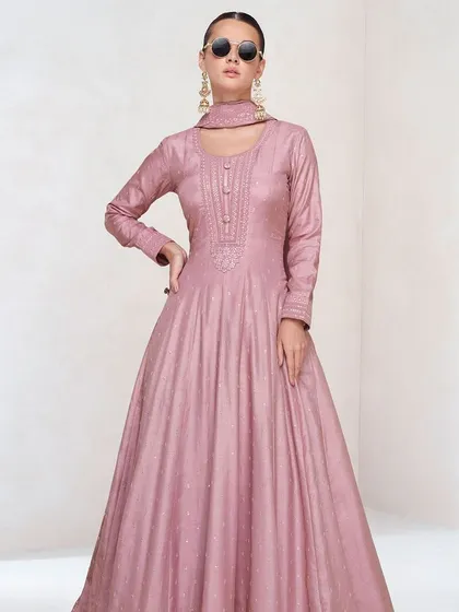 A lovely pink premium silk gown that's both simple and stunning. The thread embroidery and sequin work are focused on the yoke, creating a balanced and elegant look.