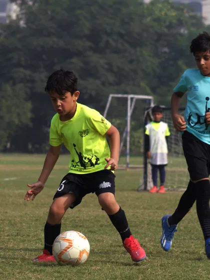 A player skillfully controls the ball, showcasing the technical ability honed in our training.
