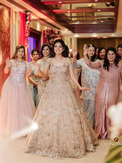 The bride makes her grand entrance with her bride squad, all dancing and smiling, setting a joyful tone for the sagan ceremony.