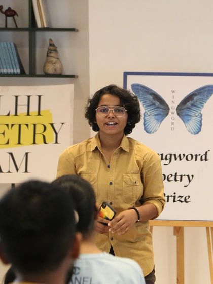 A student takes on the 60-second poetry challenge at our 'Chai & Poetry' event. These sessions are designed to be fun, fast-paced, and inspiring for young poets.