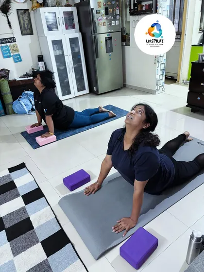 Yoga is for every body. In this session, two clients use yoga blocks to support them in Bhujangasana (Cobra Pose), modifying the posture to suit their flexibility while still getting the full benefit of the backbend.