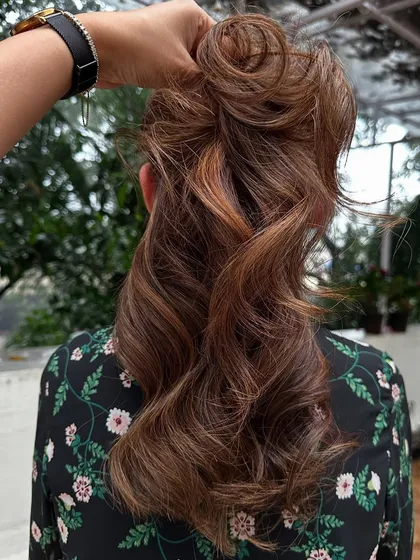 This client flew in from Dubai for my signature 'Caramello' color. I blended caramel highlights into her hair and covered her greys for a fresh, youthful look. The final style with soft waves really shows off the dimension.