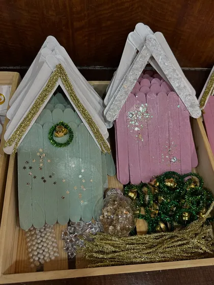 A "frame decorating" activity, where kids could embellish little wooden houses with paint and glitter.