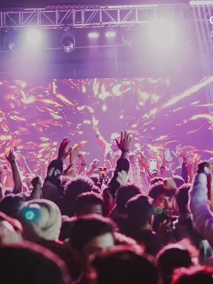 The crowd with hands in the air as the New Year begins. Capturing the peak energy of the celebration is key to showcasing the success of our events.