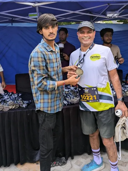 A runner receiving his finisher's medal at the Farmley Snack Run. We believe every finisher is a winner.