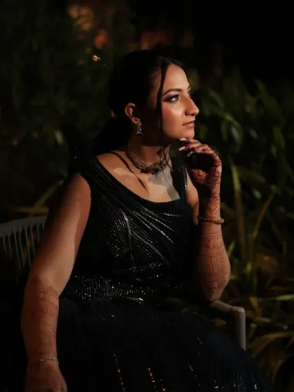 A thoughtful pose in the evening light. This profile highlights her defined jawline and the elegant simplicity of her hair and makeup.