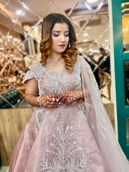 A close-up of the client in the lilac gown, showing the intricate details of her makeup and her soft, romantic curls.