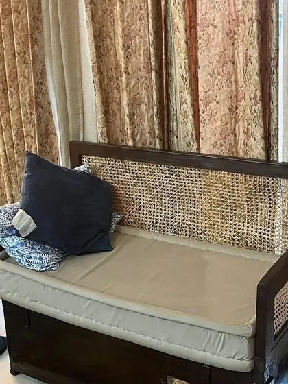 This custom-designed settee features a classic combination of wood and cane weave. It includes a comfortable cushion and built-in storage, making it a beautiful and practical piece for a living room or balcony.