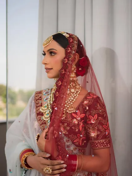 The addition of a red rose in her hair adds a classic touch to this unconventional bridal look. It’s all about the personal details.
