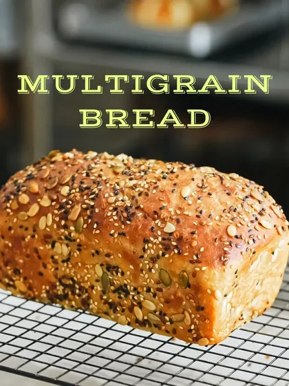 A beautiful loaf of multigrain bread, fresh from the oven. We styled this shot to highlight the texture of the crust and the variety of seeds on top.