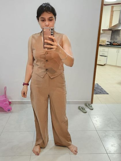 Trying on different outfits is a key step. This client is experimenting with a co-ord set to understand fit and proportion before making a final decision.