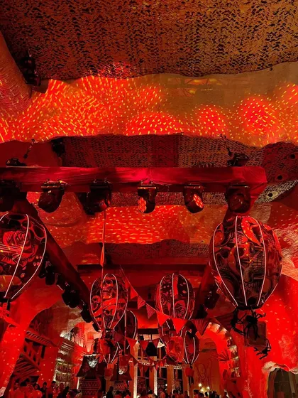 The ceiling of the Halloween party, with dramatic red lighting and custom-printed lanterns.