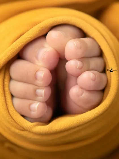 Tiny toes wrapped in a sunny yellow swaddle. This close-up is a beautiful way to remember just how small and perfect they were.
