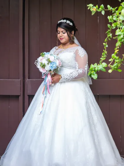 A lovely bridal portrait against a simple, rustic background. This allows the bride and her colorful bouquet to be the main focus.