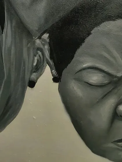 Close-up on two of the faces from the 'STATES OF MIND' mural, showing the contrast in expressions and the detailed shading on each.