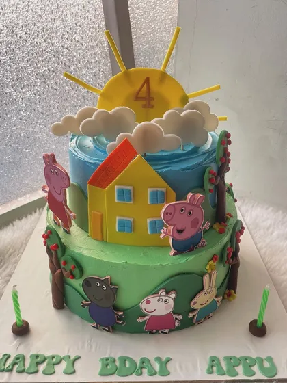 A sunny day with Peppa Pig and her family. This two-tier cake brings the beloved cartoon to life with a bright blue sky, green hills, and all the main characters ready for a party.