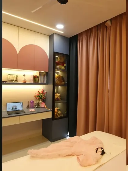 Another angle of the study area, showing the ample desk space and the beautiful integration of open and closed storage, all illuminated by soft, warm light.