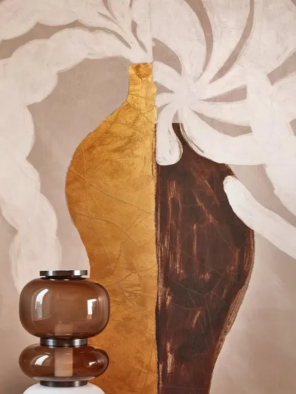 A close-up of our Kintsugi-inspired wallpaper, where the broken becomes sublime. The abstract design, featuring bold shapes in brown and metallic gold, reimagines imperfections as treasures of serene elegance.