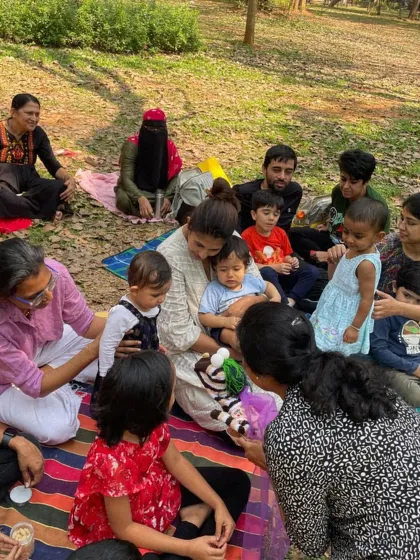 A close-up of children interacting with a zebra hand puppet. Props like these are a wonderful way to bring characters to life and encourage imaginative play during our sessions.