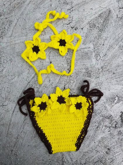 A close-up of the two-piece sunflower bikini set. This version has a unique top shaped like sunglasses made of sunflowers, paired with a brown-trimmed yellow bottom. I love creating these custom variations.